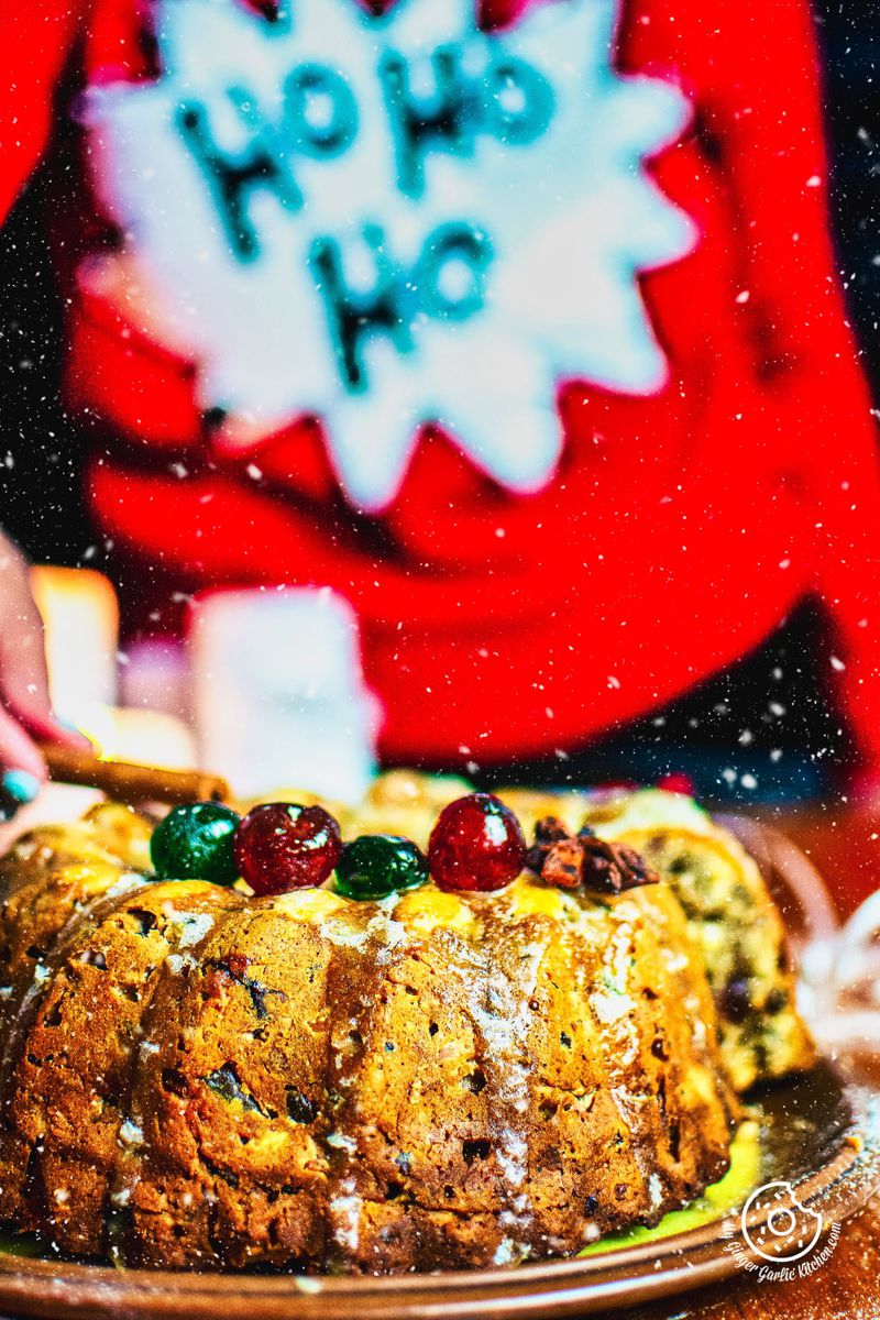 a person decorating a fruit cake