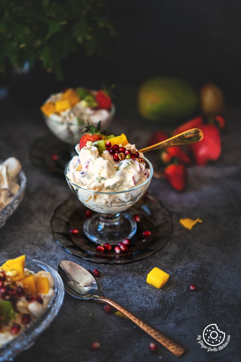 fruit cream in a transparent dessert glass with strawberries on the side