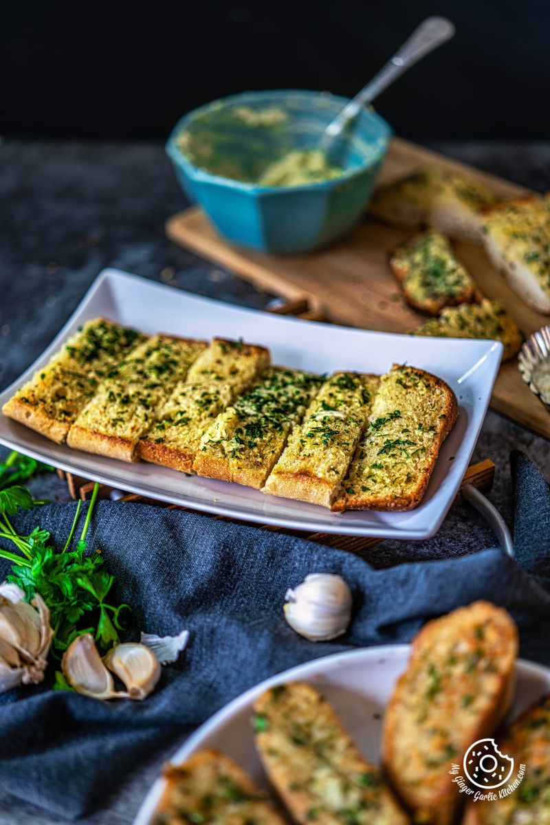 homemade garlic bread sticks in a white tray