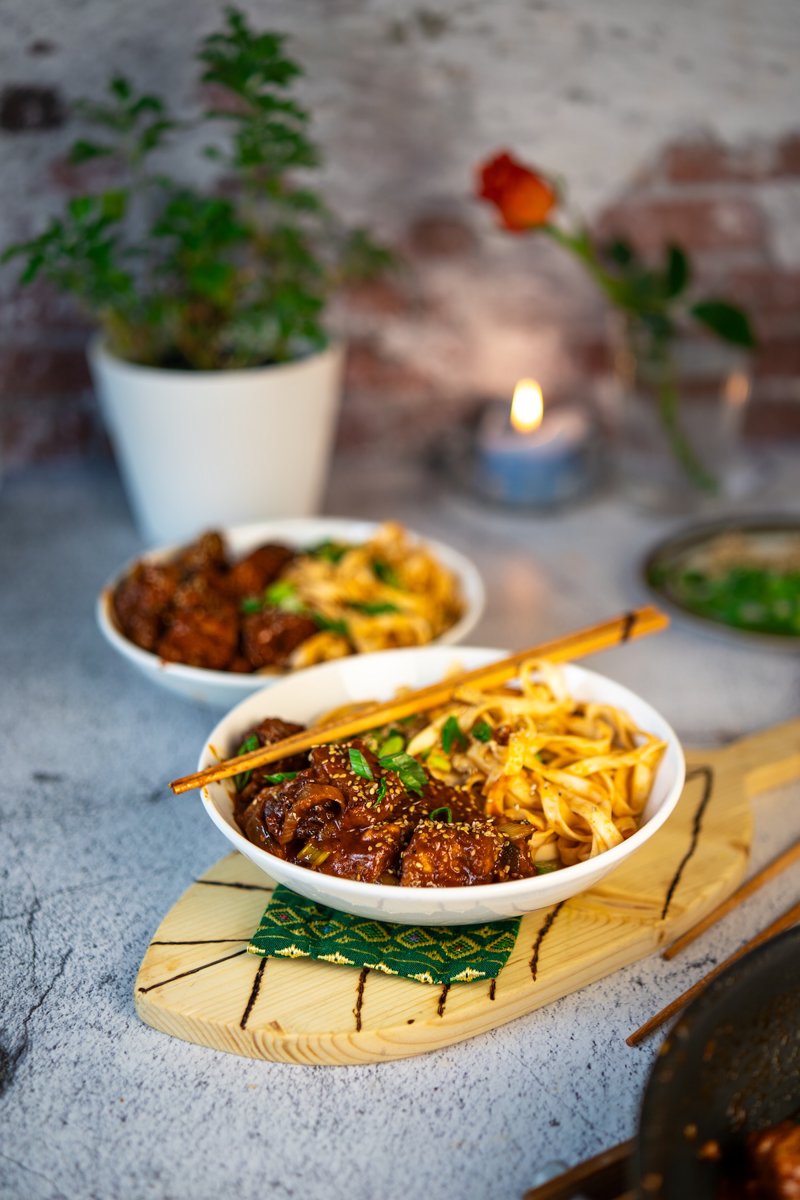 Crispy gochujang tofu with sticky gochujang sauce, sesame seeds, spring onions, and udon noodles