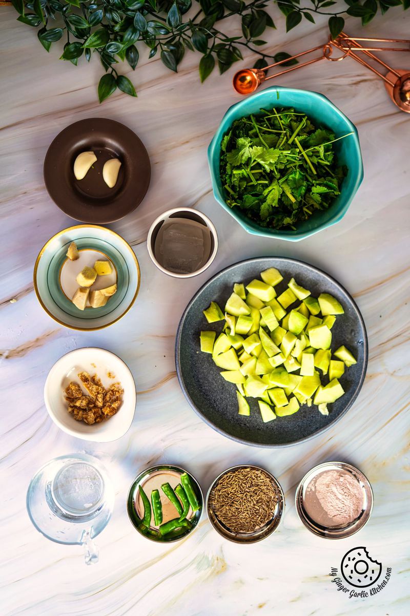 overhead photo of a table with green mango chutney ingredients