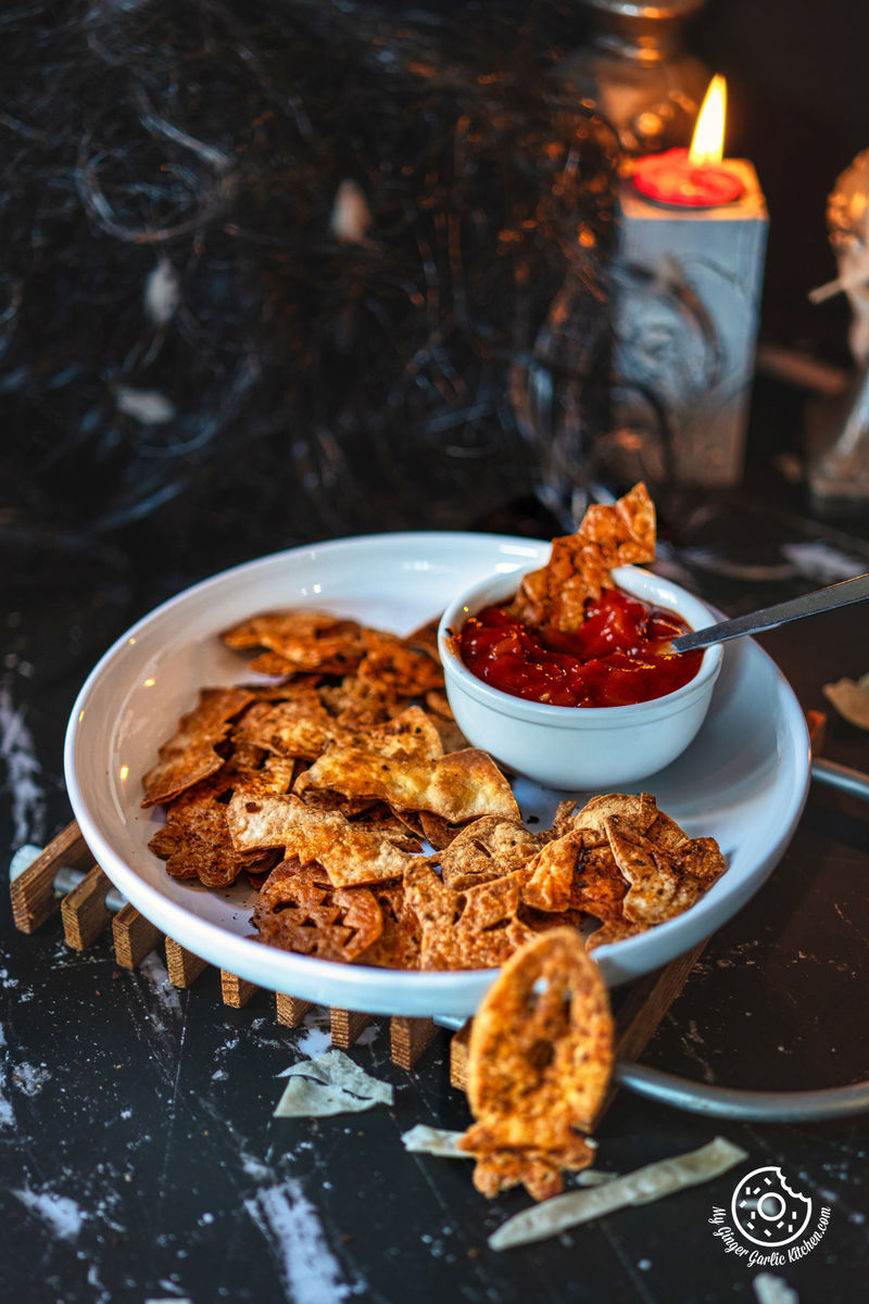 photo of a plate of Halloween Chips with a candle and a candlelight