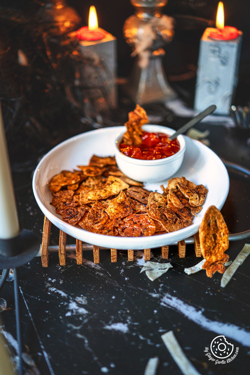 photo of a person dipping a halloween chip into a bowl of salsa