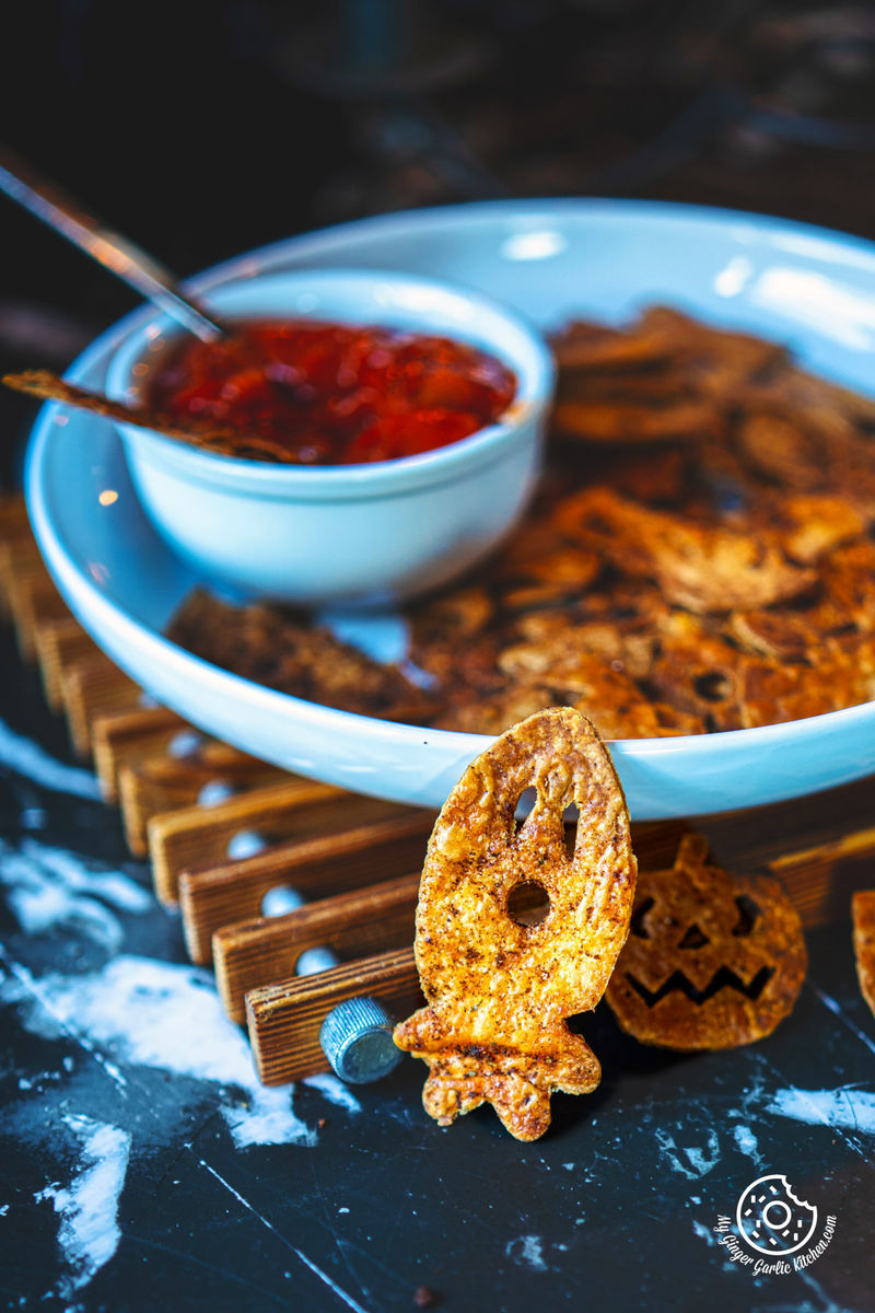 photo of a bowl of tomato salsa and a plate of baked tortilla chips