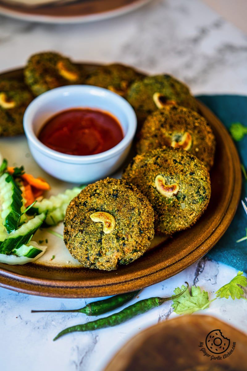 crispy hara bhara kababs in a plate with ketchup and salad