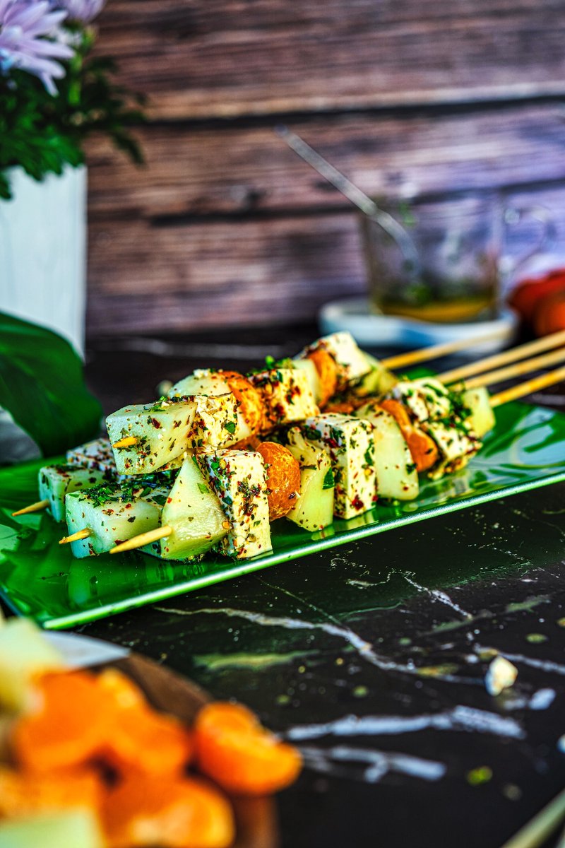 Close-up of Honeydew Melon Feta Skewers with creamy feta, sweet honeydew, juicy mandarins, and fresh herbs on a serving platter