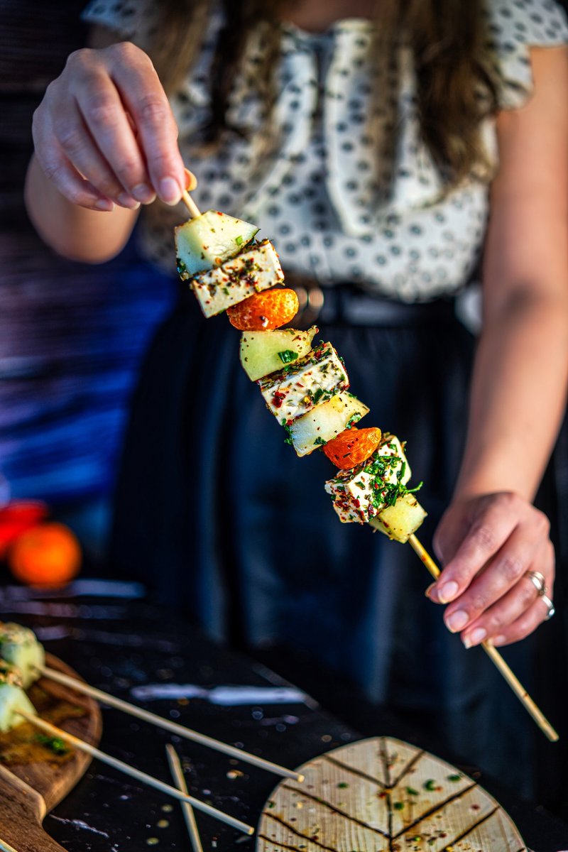 Hand holding a Honeydew Melon Feta Skewer with juicy mandarin, herbed feta, and sweet honeydew for an easy summer appetizer