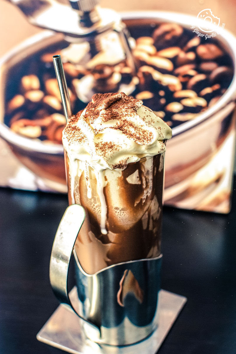 there is a cold coffee with whipped cream and chocolate toppings