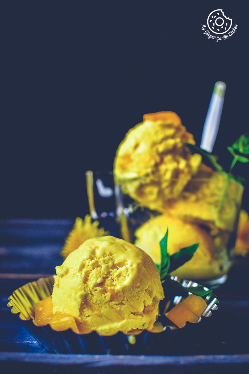 three scoops of mango ice cream on a plate
