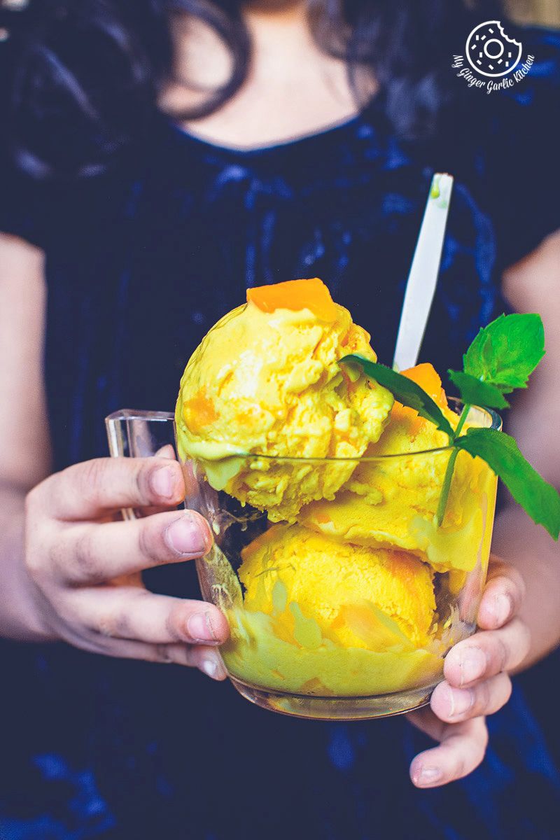 a person holding a bowl of manfo ice cream with a spoon