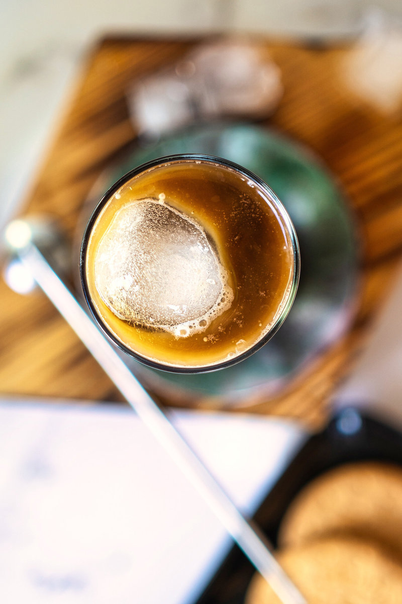 Top view of an Iced Spanish Latte showcasing the rich coffee color and a large, clear ice cube.