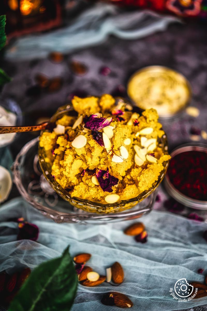 instant badam halwa garnished with sliced almonds and saffron transparent bowl served in a transparent bowl