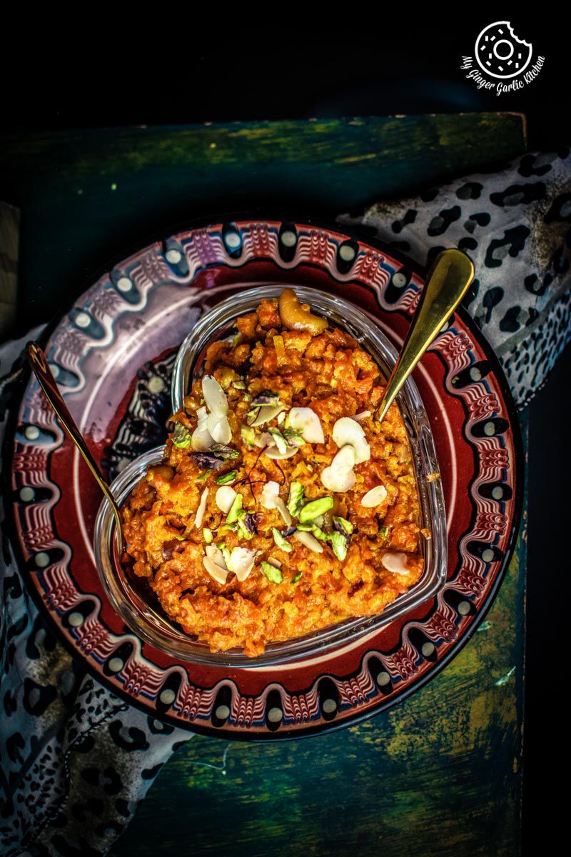 a bowl of instant pot gajar halwa with a spoon on a table