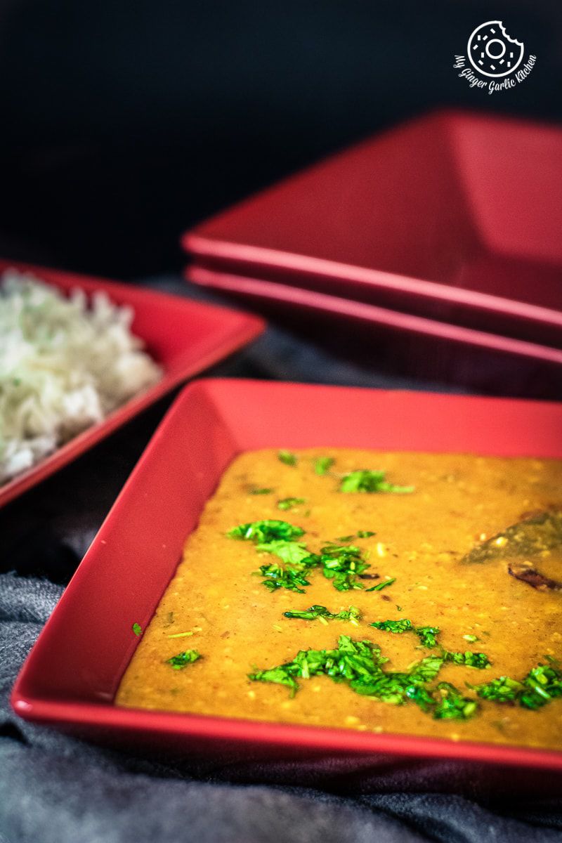 instant pot masoor dal tadka served in a red dish