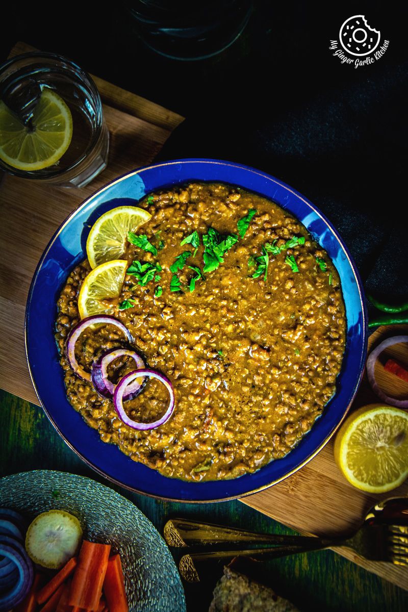 whole green moong dal served in a blue plate
