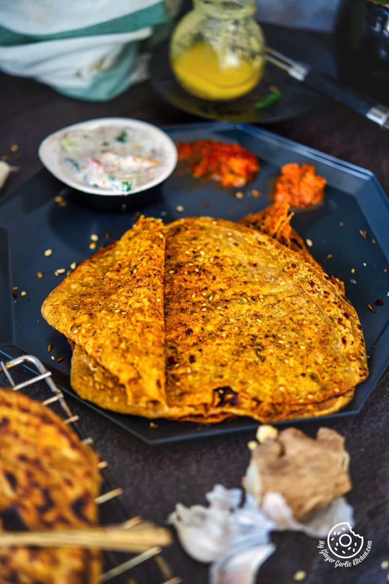 open triangle khichdi paratha showing the spice filling from inside
