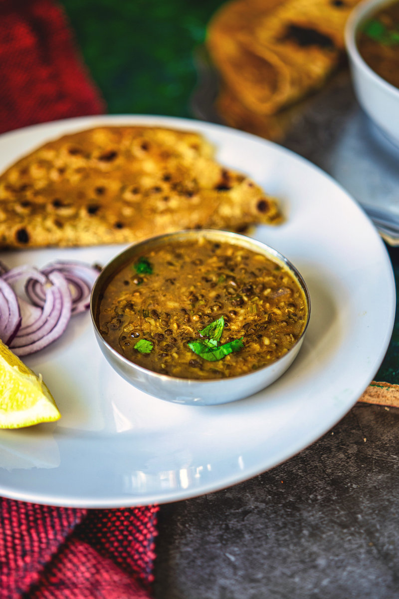 Maa Ki Dal served in a simple white bowl with a side of lemon and sliced onions, perfect for a comforting meal.