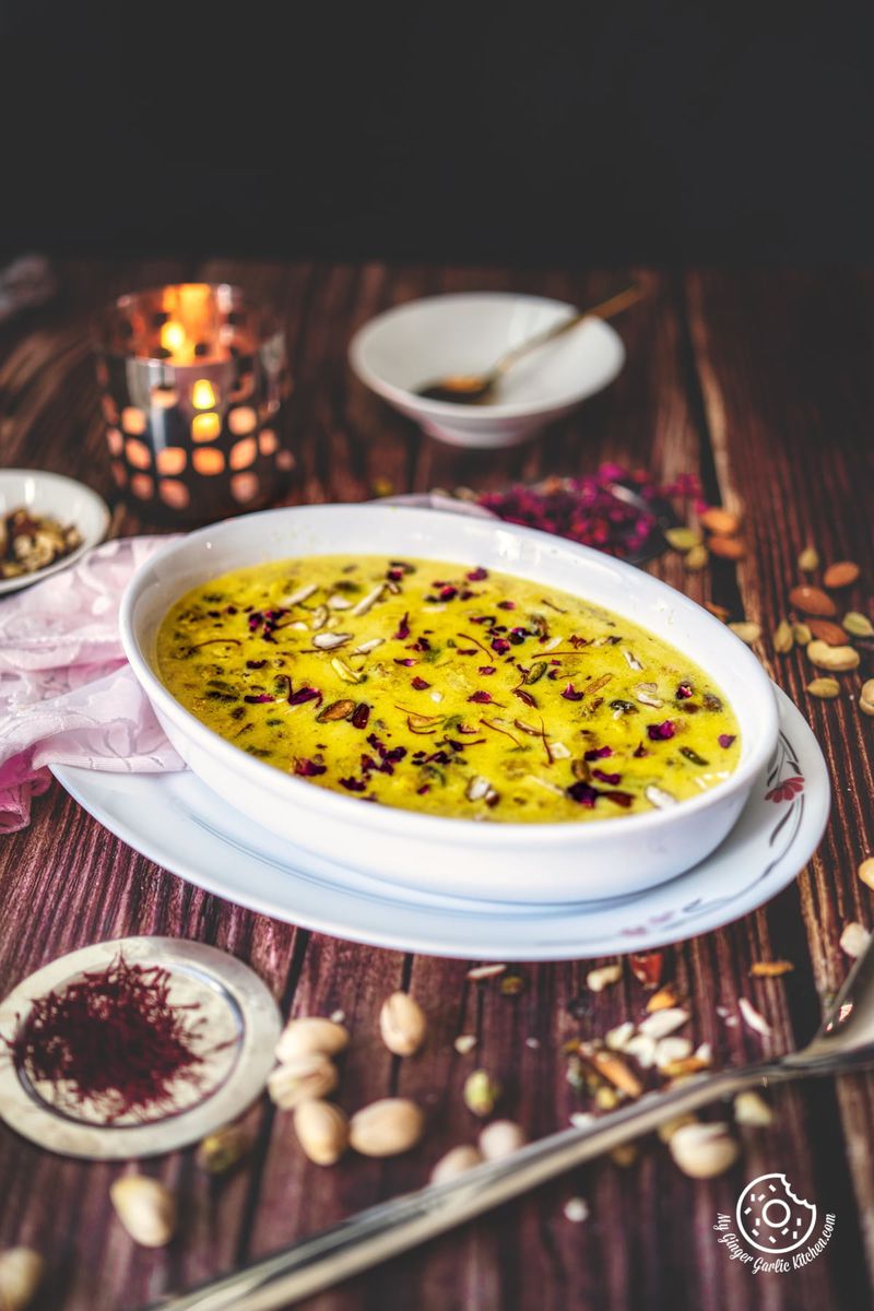 makhana kheer in a white oval shaped bowl and a candle in the background