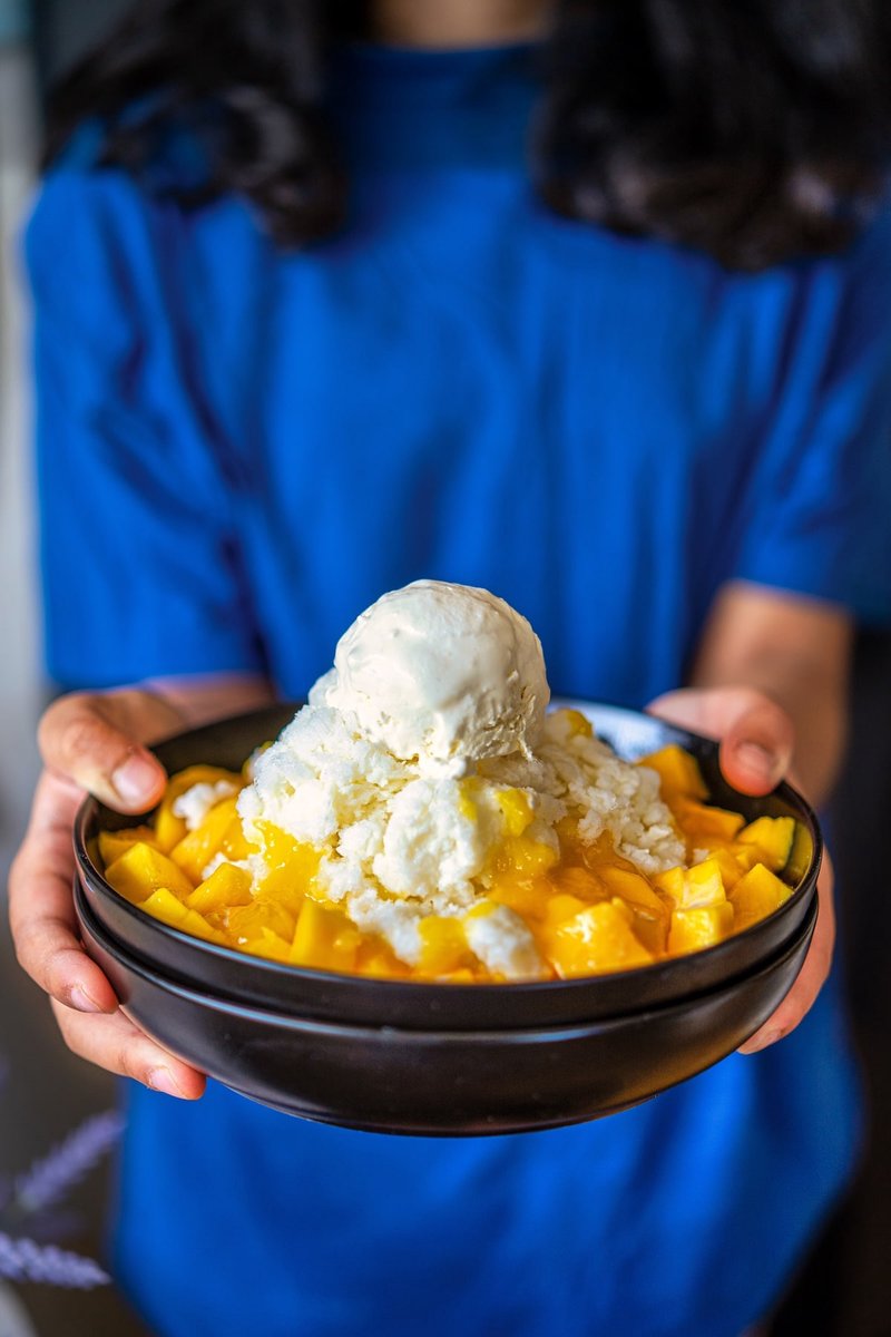 Homemade Mango Bingsu served in a bowl with fluffy milk ice, juicy mangoes, and vanilla ice cream