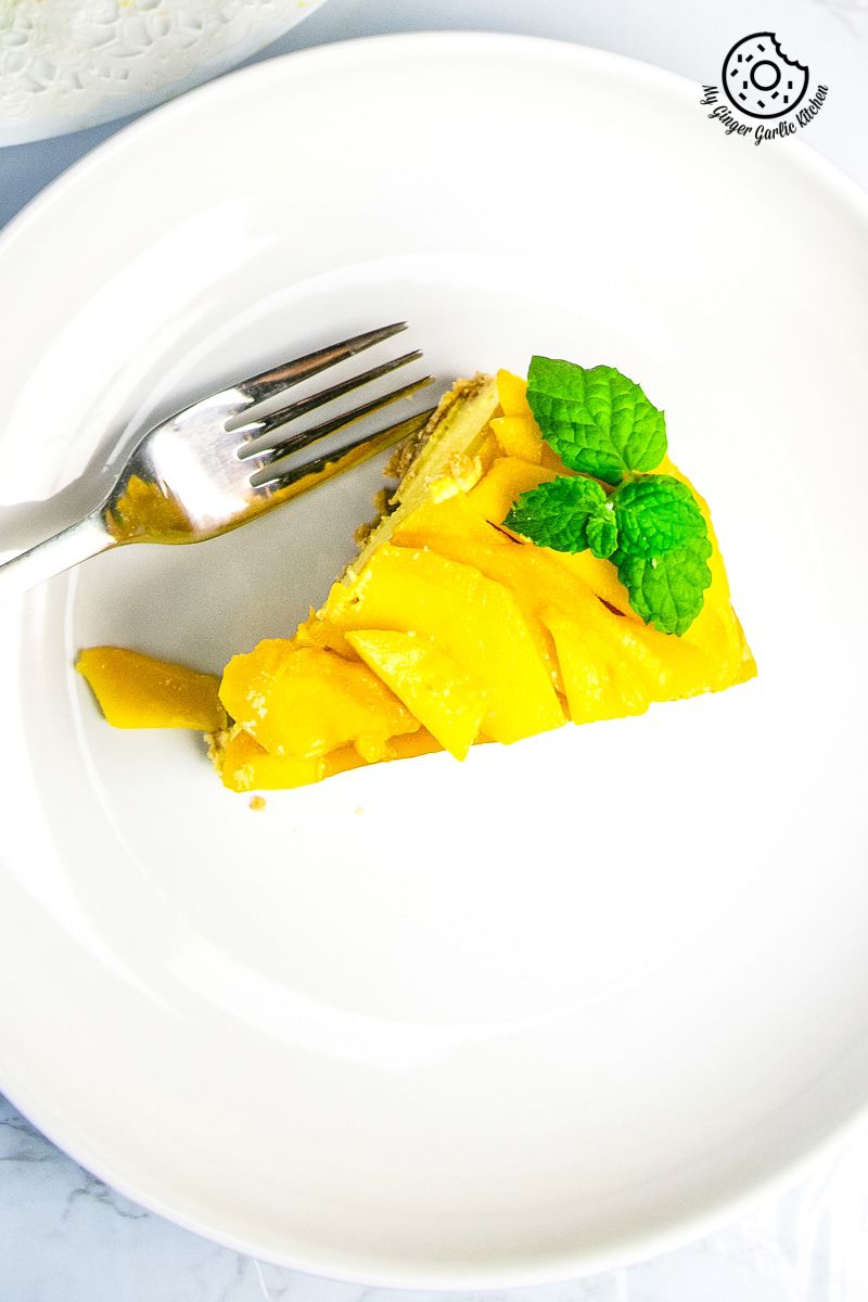 no bake mango cheesecake slice served in white plate