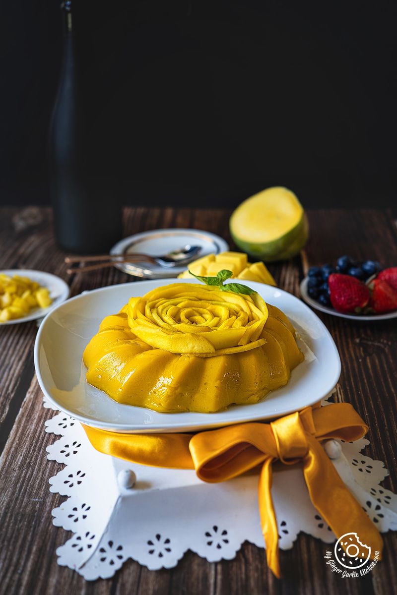 mango pudding decorated with mango rose kept in a white plate