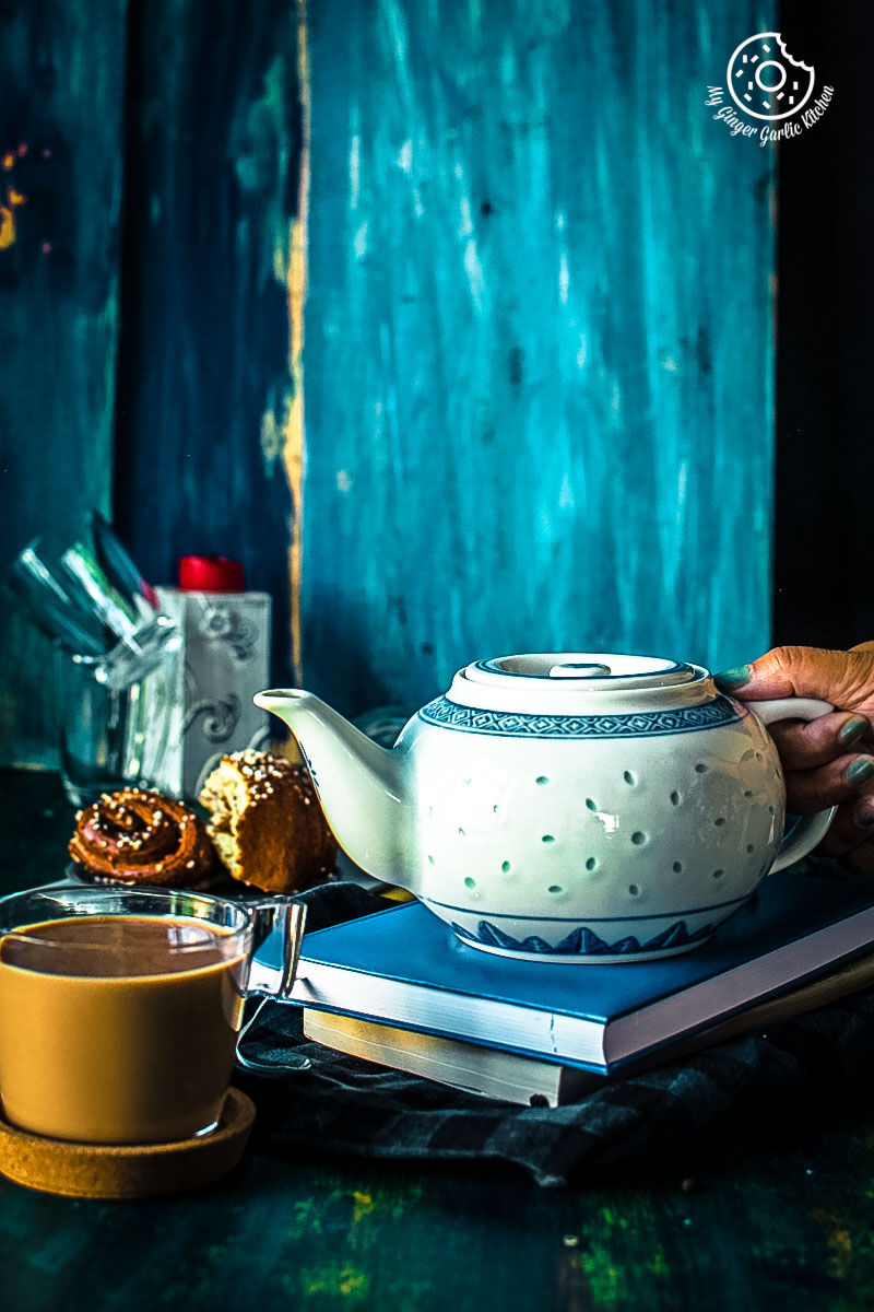 tea pot and a cup of masala chai tea on a table