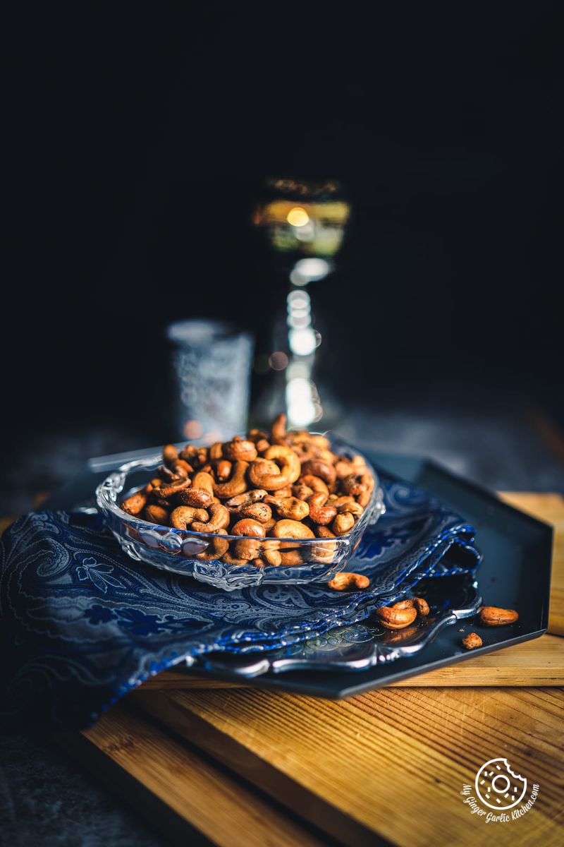 masala kaju (spicy roasted cashew nuts) served in a heart shape transparent bowl