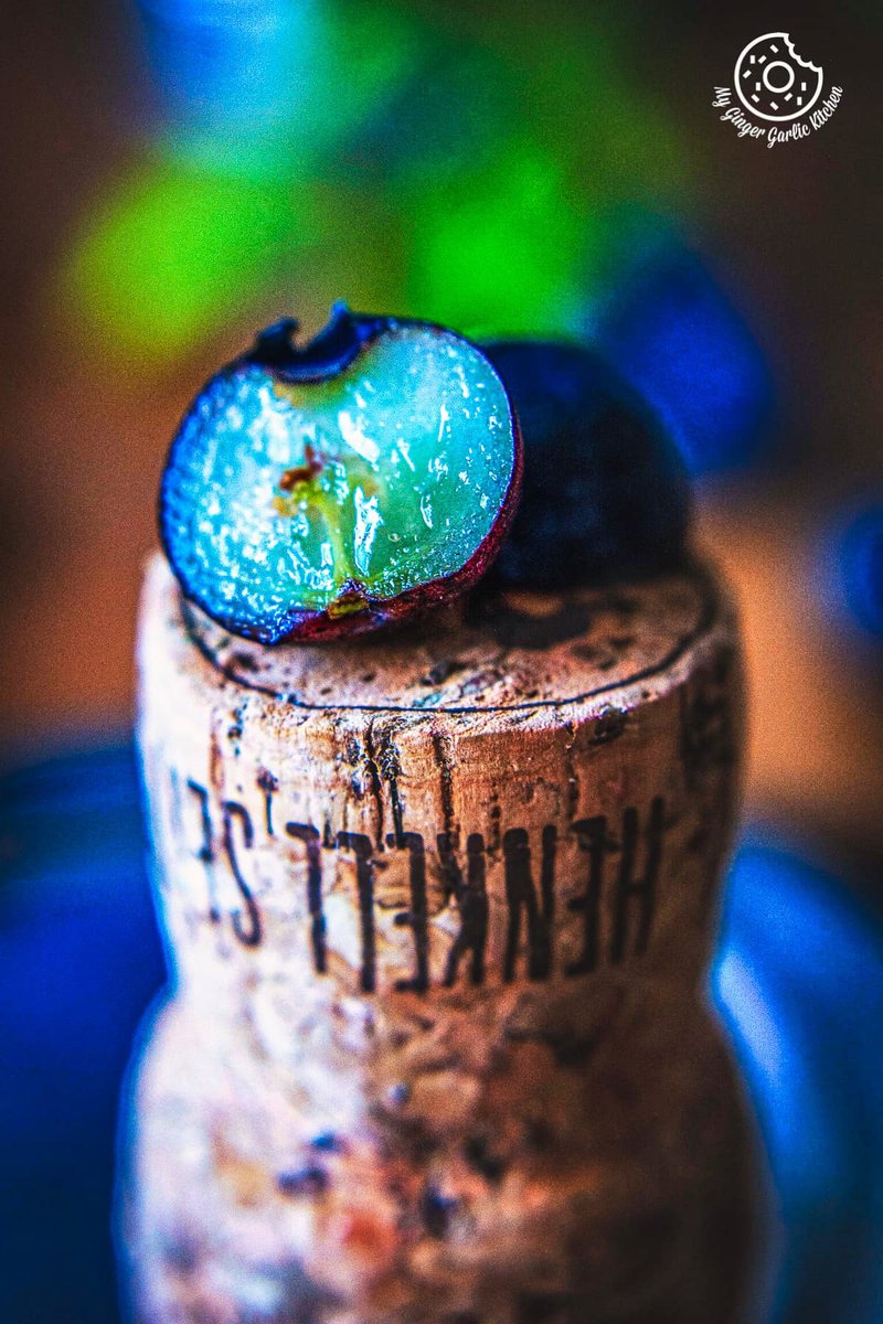 macro photo of  a half sliced blueberry on top of a cork stopper