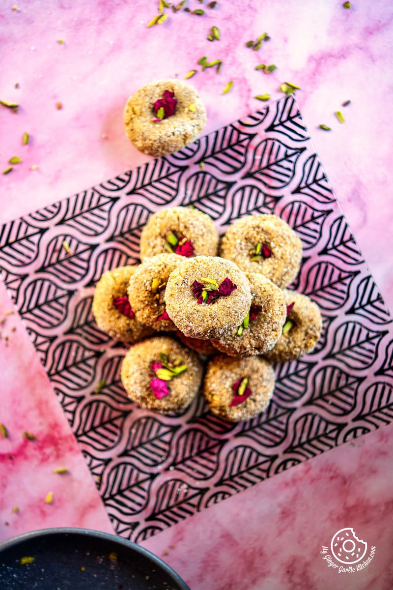 photo of a pile of mathura peda on a pink background