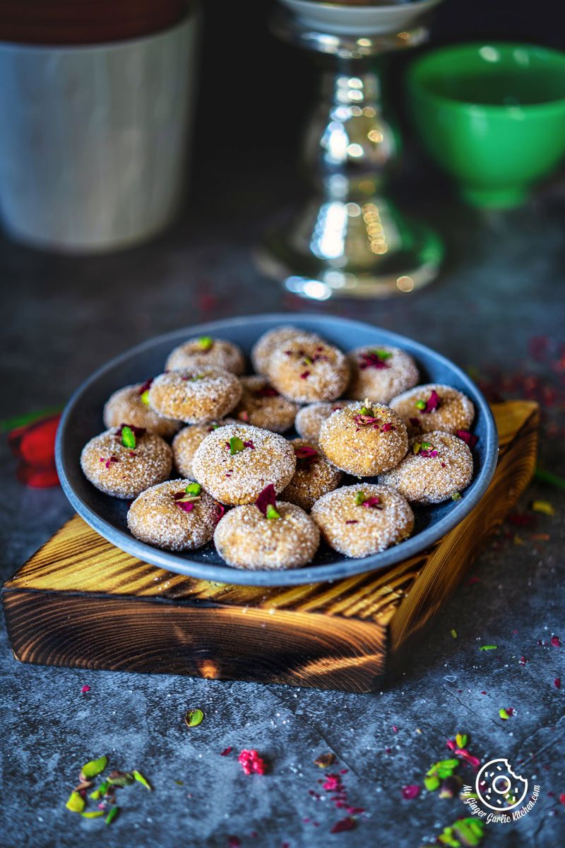 photo of a plate of sugared mathura on a wooden board