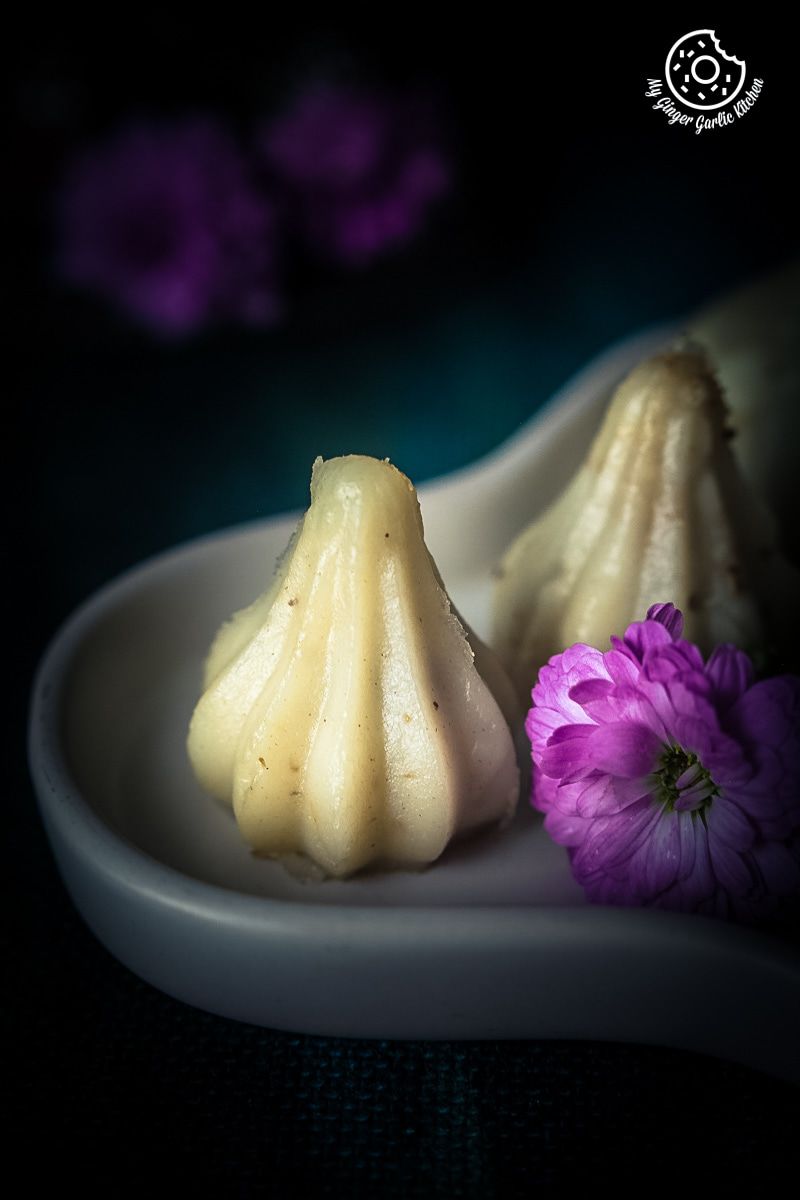 ukadiche or steamed modak on a plate with flowers