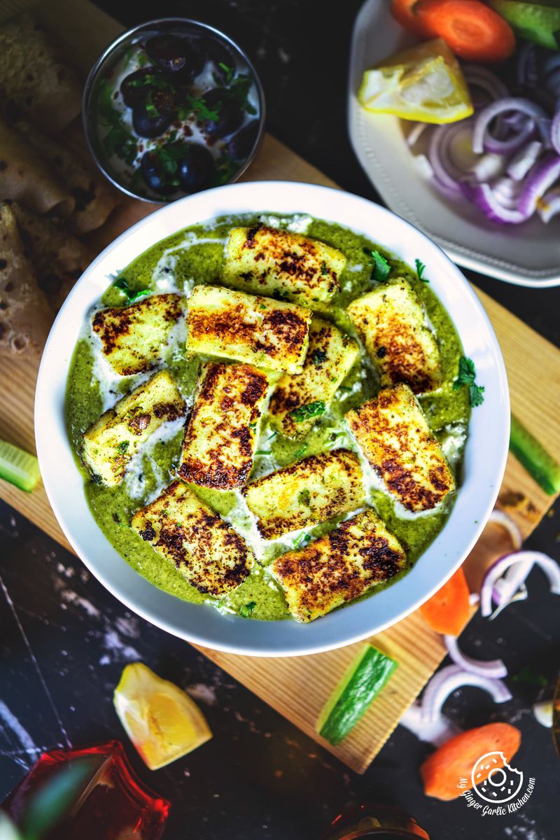 overhead close up view of paneer afghani in a white bowl