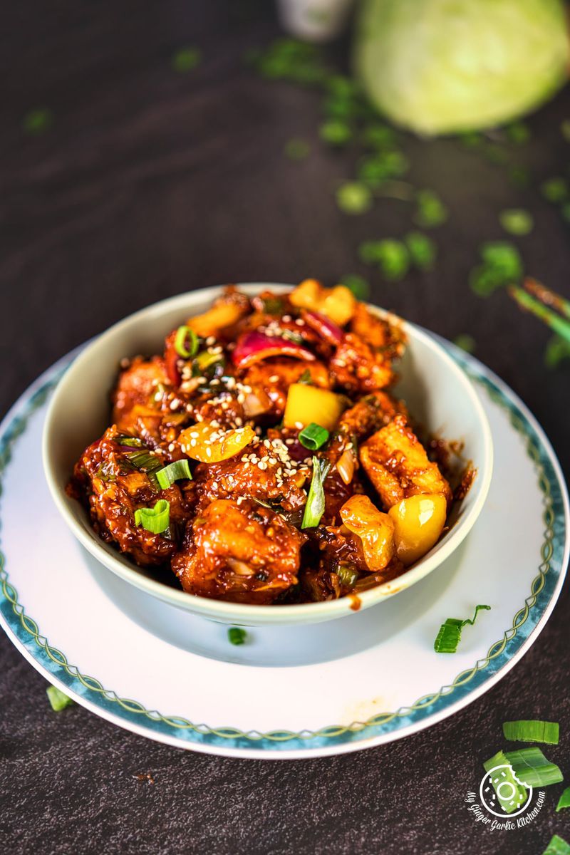 crisp fried paneer manchurian served in a pale green bowl