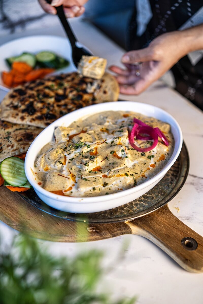 Serving paneer nawabi with naan, creamy white gravy paneer curry without tomato for a restaurant style meal