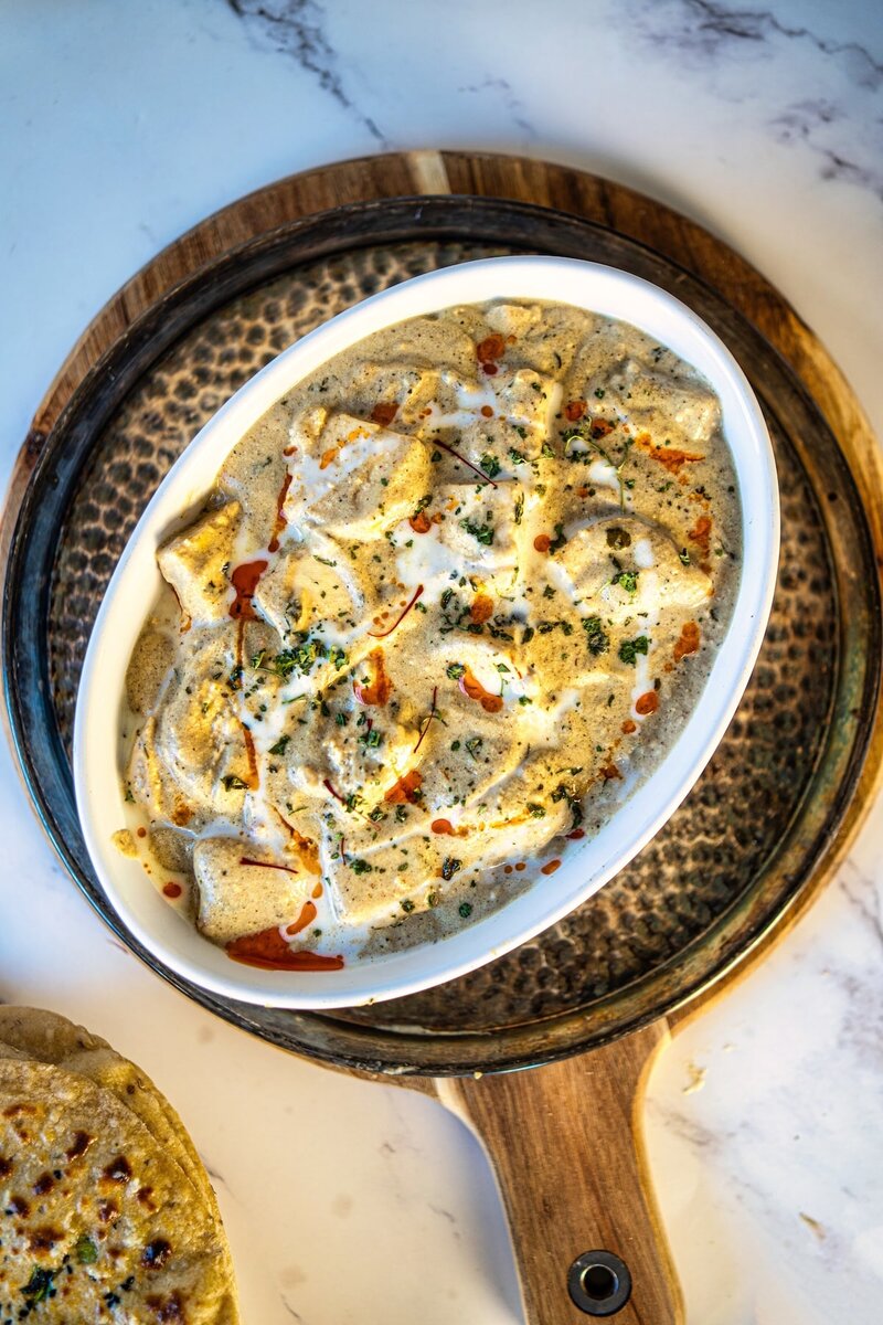Creamy paneer nawabi white gravy curry without tomato served in a bowl, rich and smooth restaurant style paneer curry