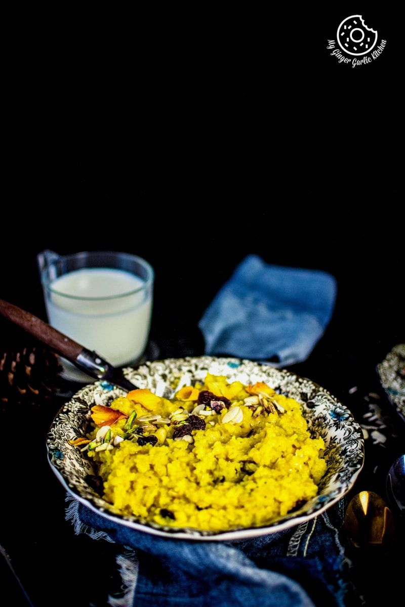 a plate of jaipuri paush khichda aka sweet dal khichdi with a glass of milk