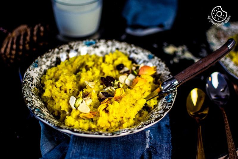 a bowl of jaipuri paush khichda aka sweet dal khichdi with almonds and raisins on it