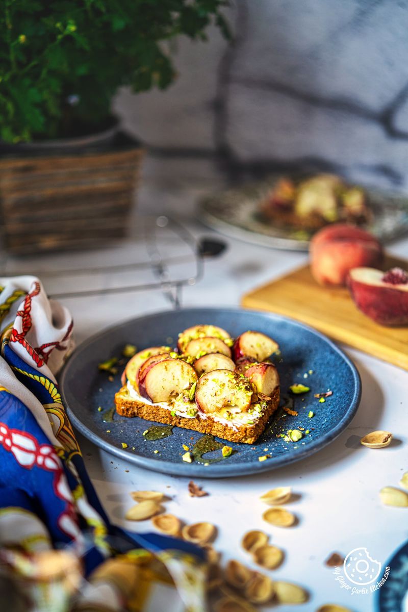 photo of a plate of peach toast on a table with a napkin