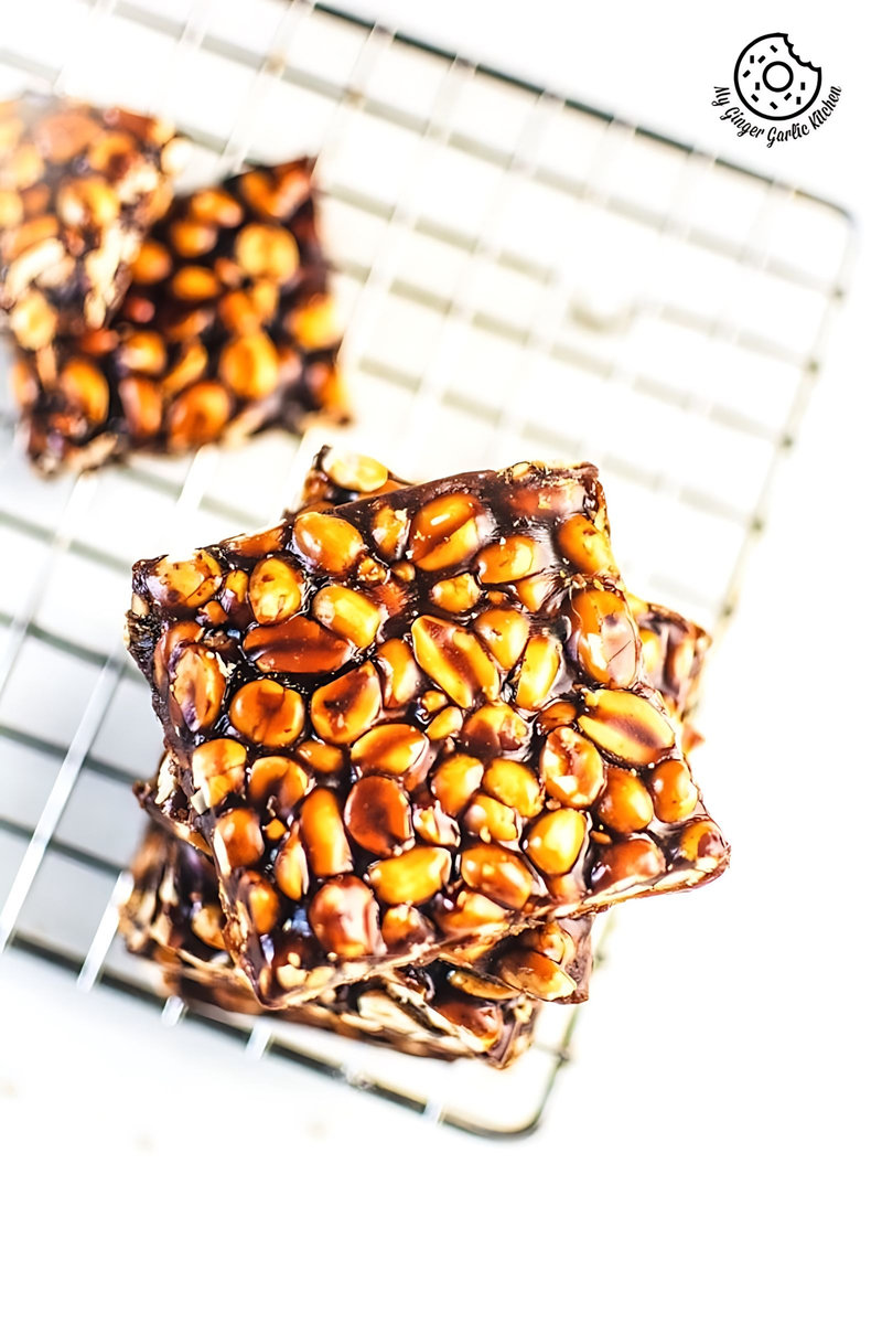 few pieces of peanut chikki on a cooling rack
