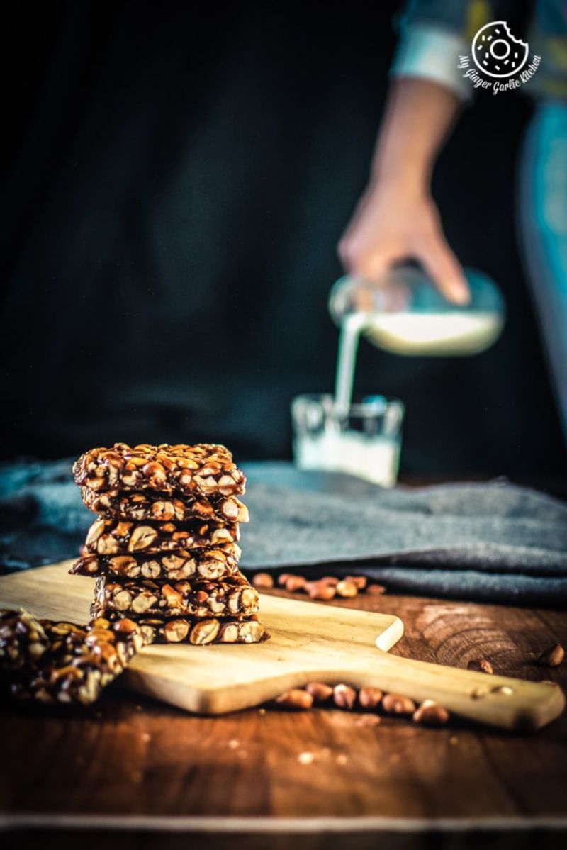 a stack of peanut chikki on a cutting board
