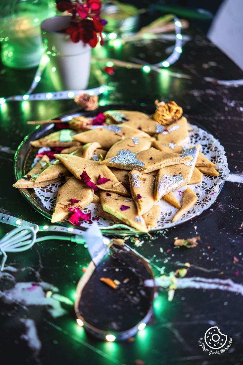 peanut katli decorated with silver leaves and rose petals