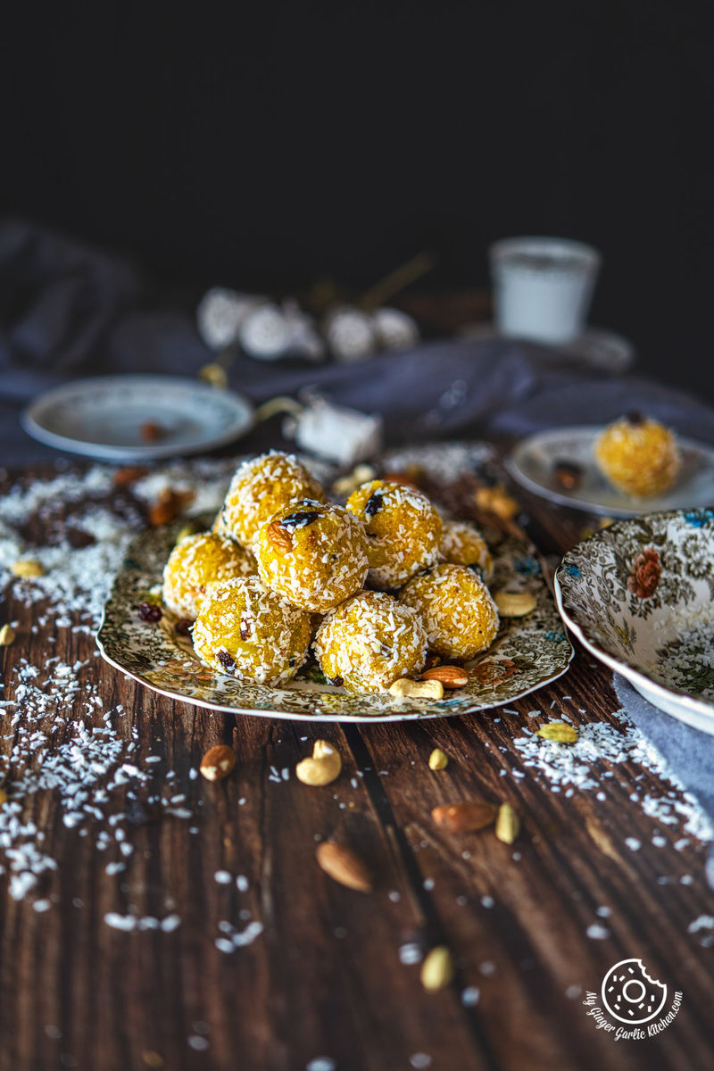 stack of pineapple ladoos on a floral plate