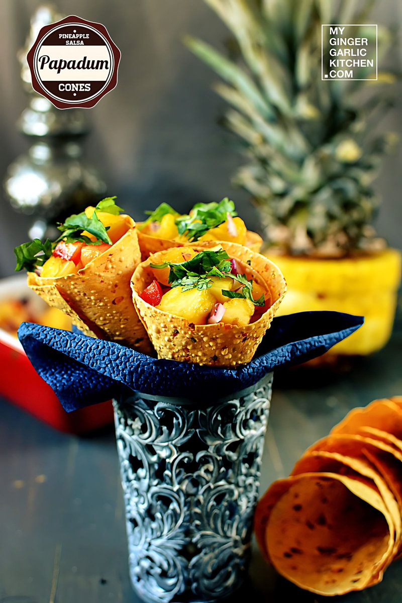 a grey vase with some pineapple salsa papadum cones in it