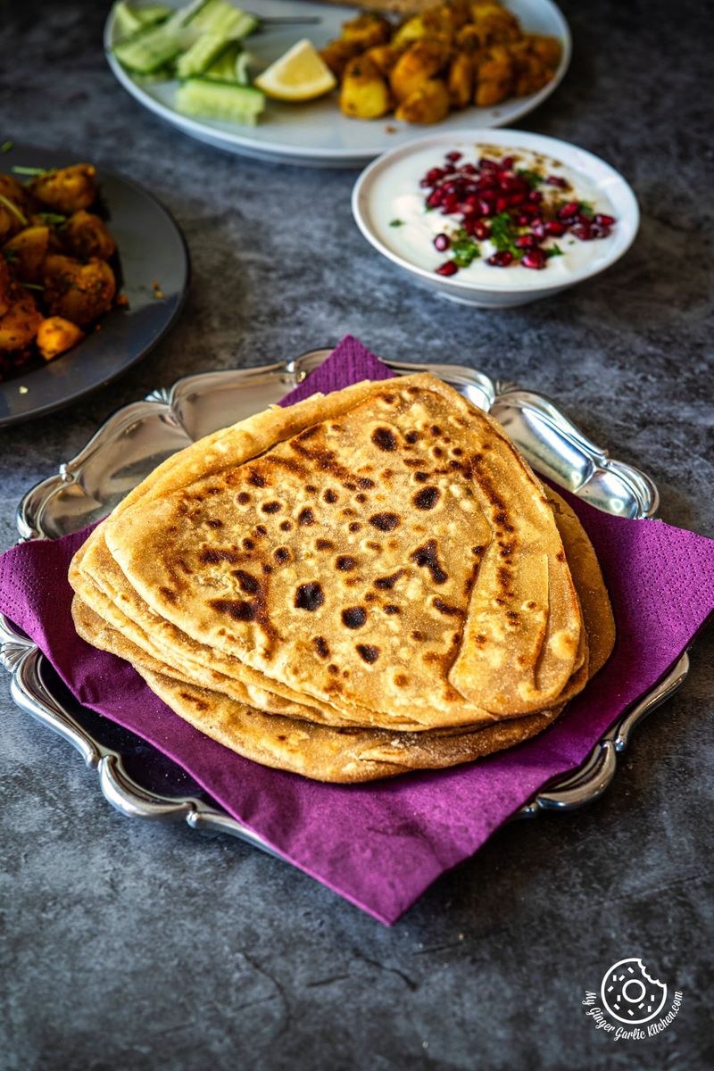 photo of a plate of plain paratha Indian flatbread on a purple napkin