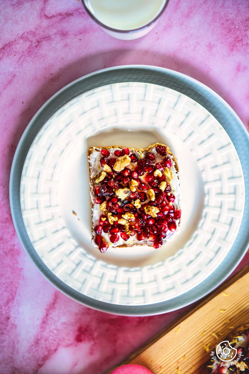  a plate with a piece of pomegranate toast on it