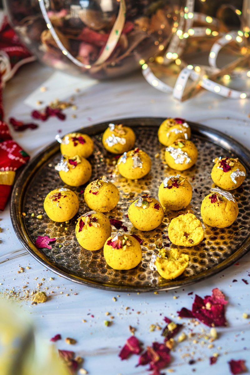 Rasmalai Ladoo arranged on a decorative platter, garnished with edible silver leaf and rose petals.