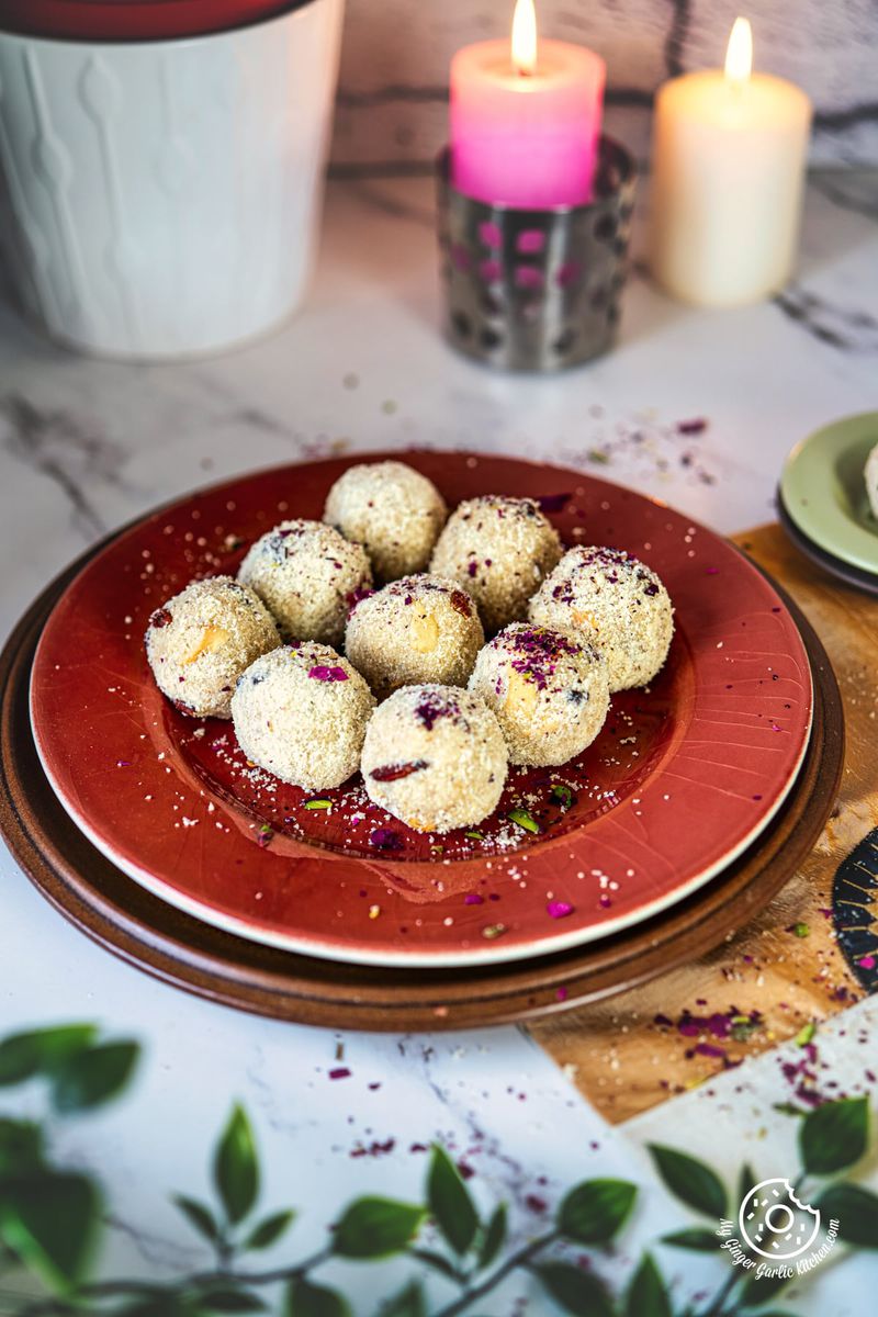 photo of a plate of suji ladoos on a table with candles