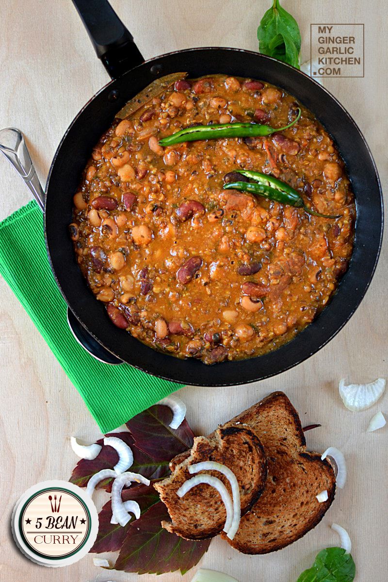 a pan of chili and bread on a table