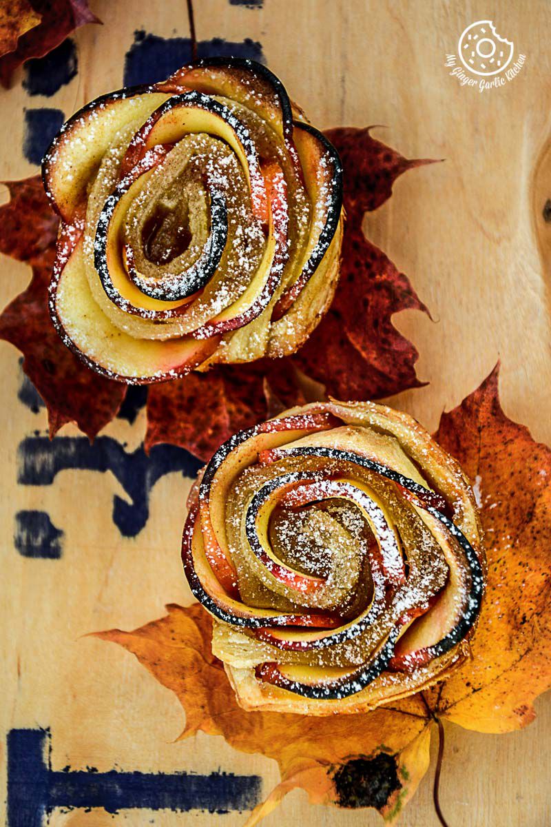 two apple rose mini tartlets that are sitting on a table