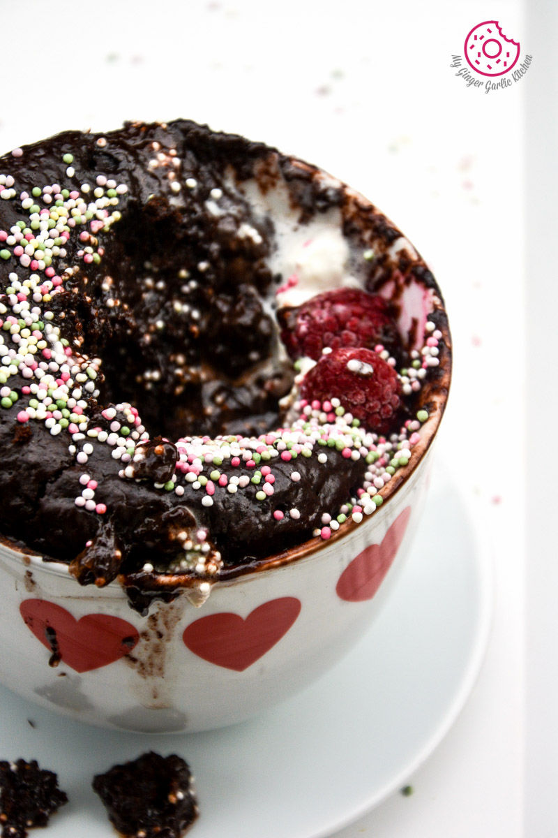 chocolate molten lava mug cake in a cup with sprinkles on it